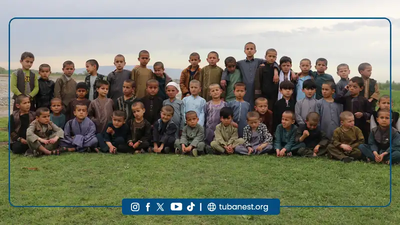 Children of Tuba Nest participating in organized sports activities including warm-up exercises and football training in Takhar province, Afghanistan.