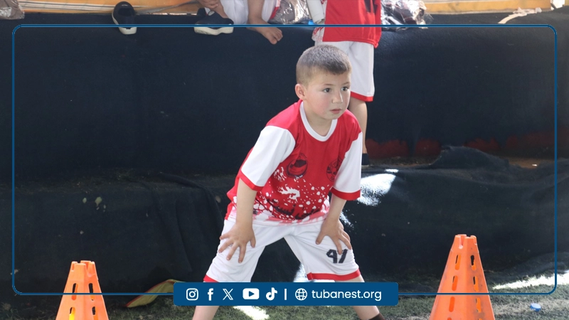 Children participating in a sports and recreational program organized by Tuba Nest in Taloqan, including football activities and a joyful Shir Yakh treat, promoting health, happiness, and child development.