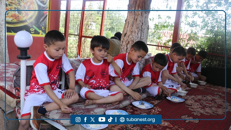 Children participating in a sports and recreational program organized by Tuba Nest in Taloqan, including football activities and a joyful Shir Yakh treat, promoting health, happiness, and child development.
