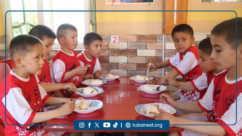 Children participating in a sports and recreational program organized by Tuba Nest in Taloqan, including football activities and a joyful Shir Yakh treat, promoting health, happiness, and child development.
