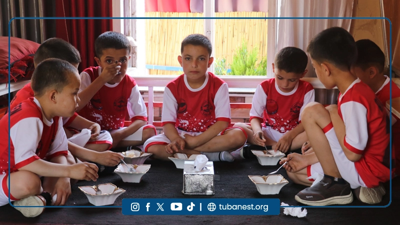 Children participating in a sports and recreational program organized by Tuba Nest in Taloqan, including football activities and a joyful Shir Yakh treat, promoting health, happiness, and child development.